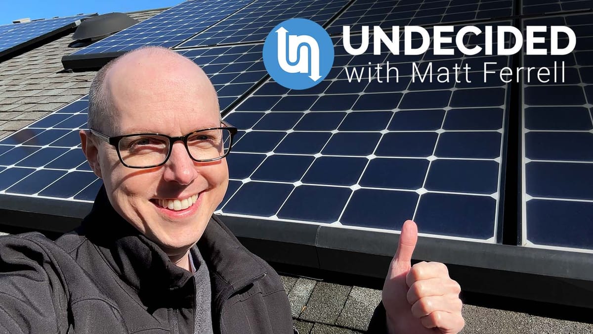 Matt Ferrell on his roof beside his solar panels